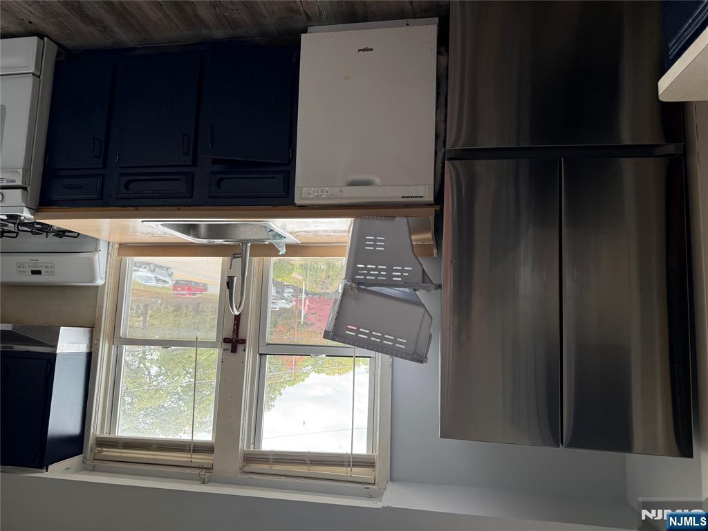 129 Orient Way, Unit 2 Lyndhurst, NJ 07071 - Photo 6 of 29 a kitchen with stainless steel appliances granite countertop a refrigerator and a sink