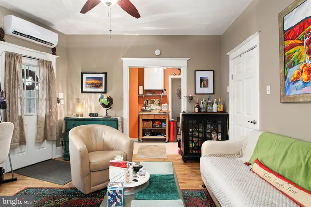 a living room with fireplace furniture and a large window