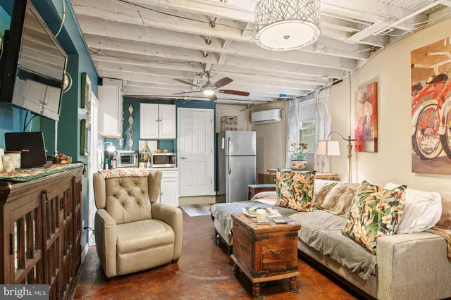 a living room with furniture and a chandelier