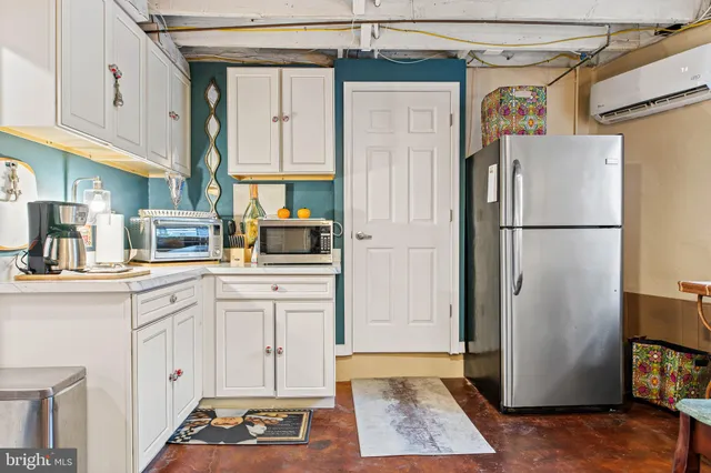 a kitchen with a refrigerator a stove and cabinets