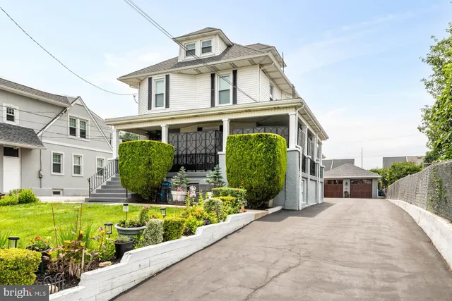 a front view of a house with a garden and plants