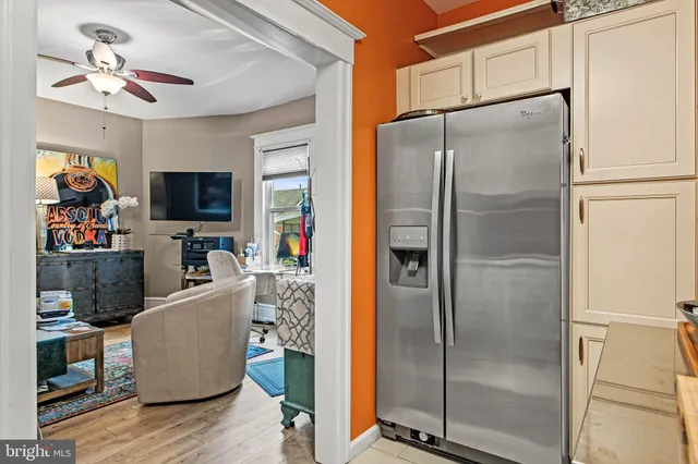 a kitchen with stainless steel appliances a refrigerator a stove a microwave oven with cabinets and wooden floor