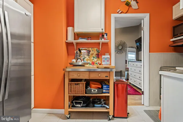 a kitchen with stainless steel appliances granite countertop a refrigerator and a stove