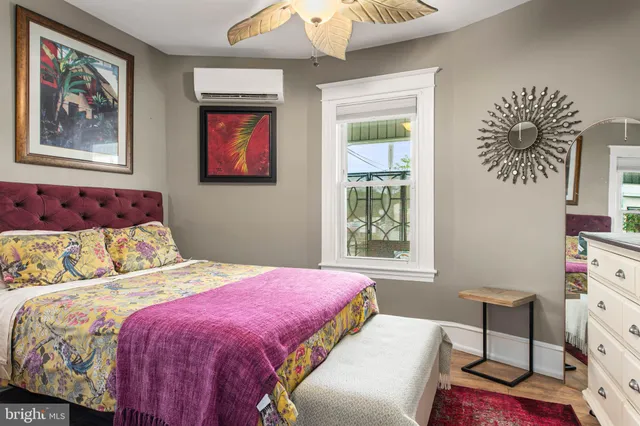 a bedroom with a bed and a painting on the wall