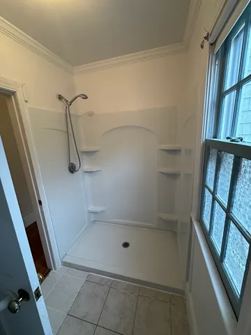 a bathroom with a glass door shower