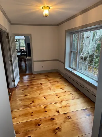 a view of a room with wooden floor and staircase