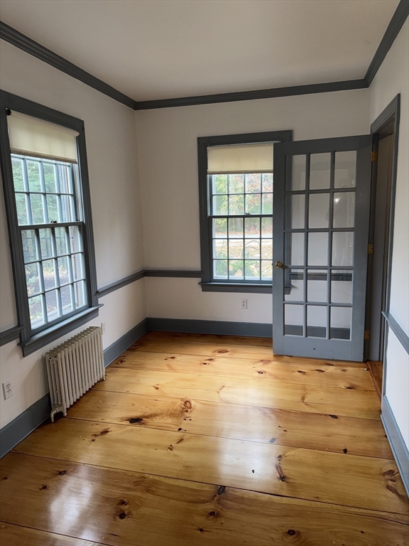 191 Chestnut Street, Unit 1 Duxbury, MA 02332 - Photo 8 of 20 a view of an empty room with a window and wooden floor