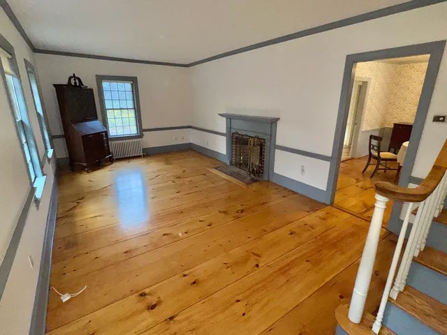 a view of a kitchen with wooden floor and chair
