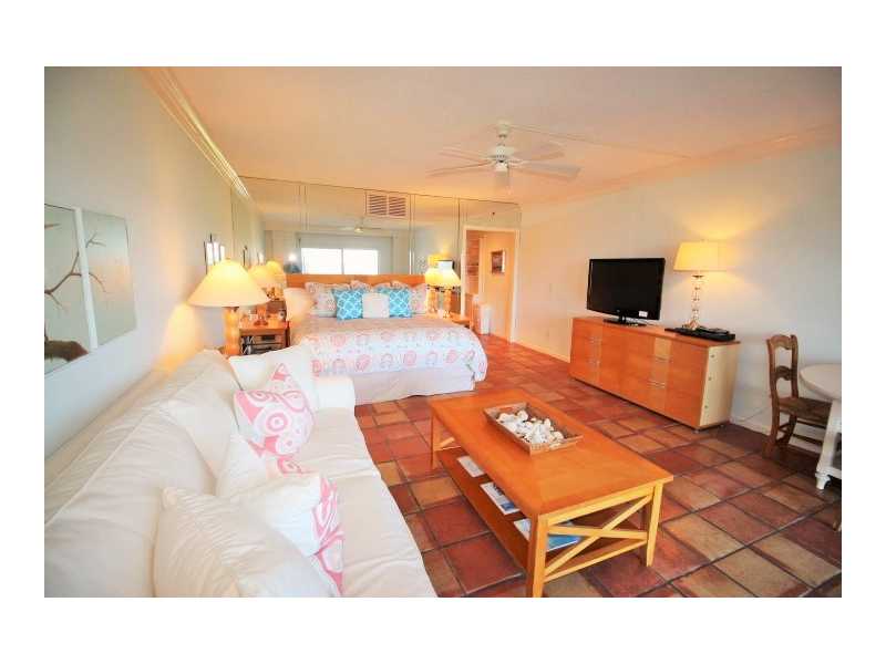 400 Beach Road, Unit 141 Vero Beach, FL 32963 - Photo 4 of 11 a living room with furniture a flat screen tv and a table