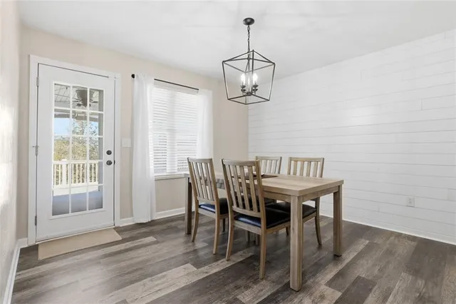 a view of a dining room with furniture wooden floor and chandelier
