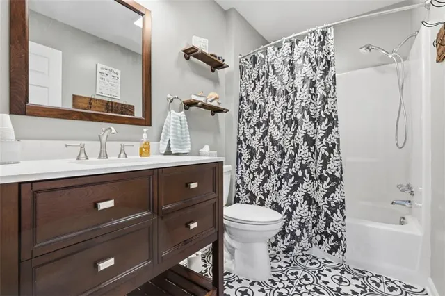 a bathroom with a sink toilet a shower and a mirror