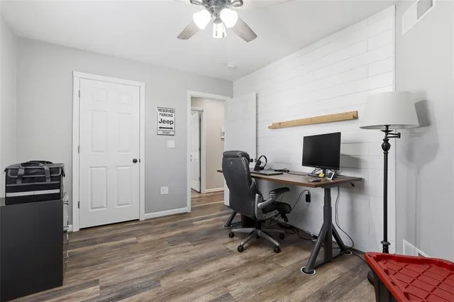 a view of a workspace with furniture and a window