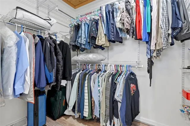 a view of walk in closet with clothes