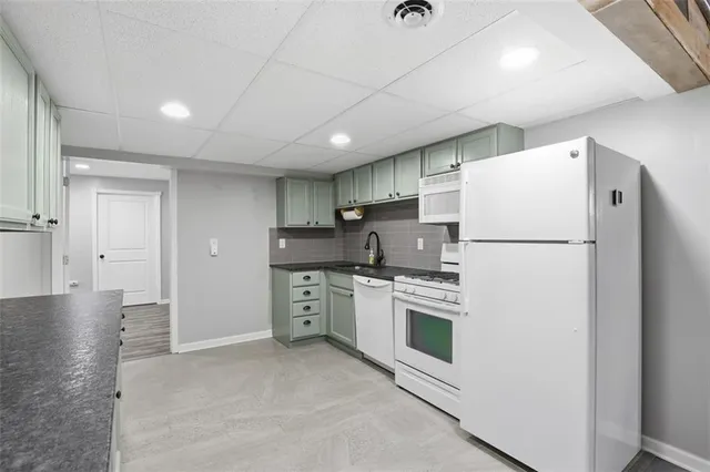 a kitchen with stainless steel appliances a refrigerator sink and cabinets