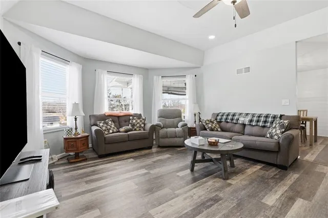 a living room with furniture and a large window