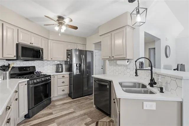 a kitchen with stainless steel appliances a sink stove and refrigerator