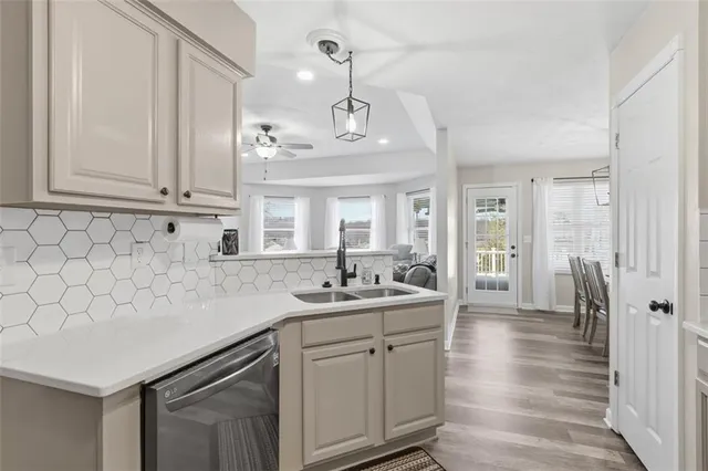 a kitchen with sink cabinets and wooden floor