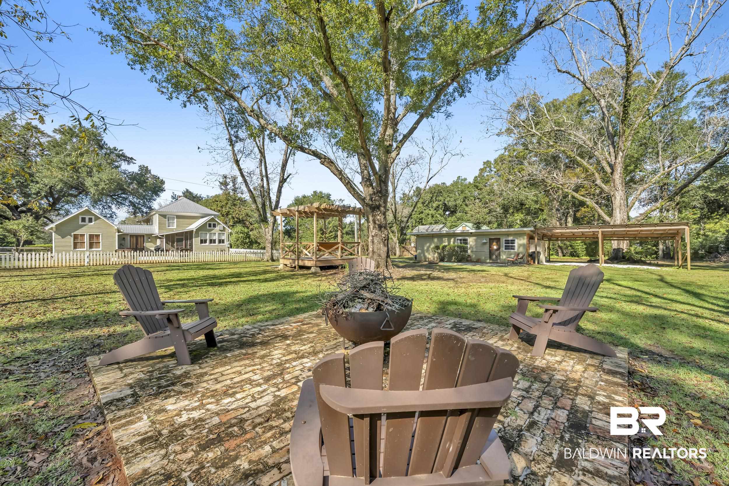 13232 Mary Ann Bch Road Fairhope, AL 36532 - Photo 55 of 79 View of grassy yard with an outdoor fire pit and a patio area