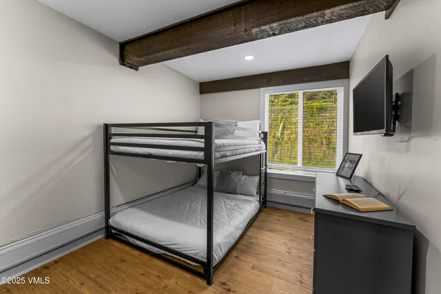 a bathroom with a toilet a sink a mirror a bathtub and shower