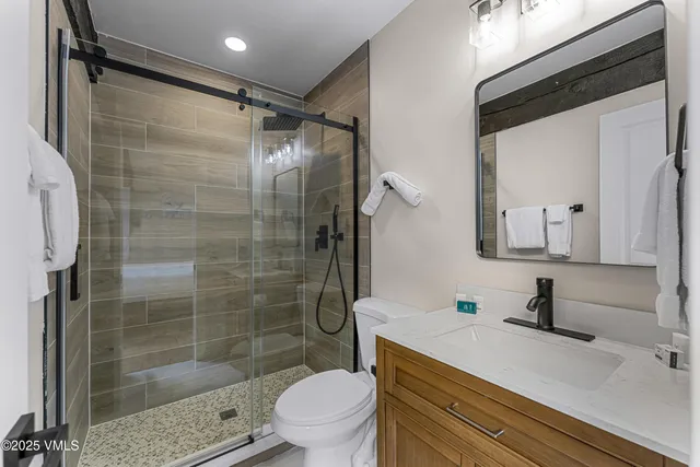 a dining room with furniture a large window and a fireplace