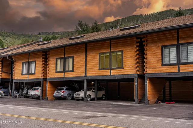a kitchen with a sink a counter and chairs