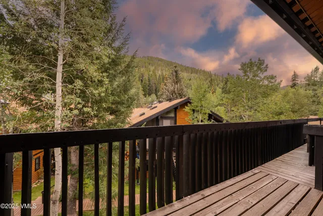 a view of a houses with a lush green hillside