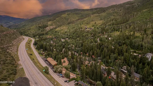 a view of a roof deck with wooden fence and plants