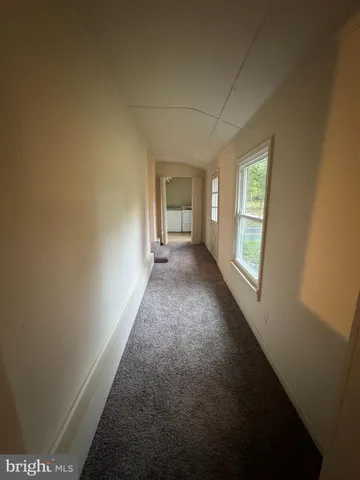 a view of a hallway with a window