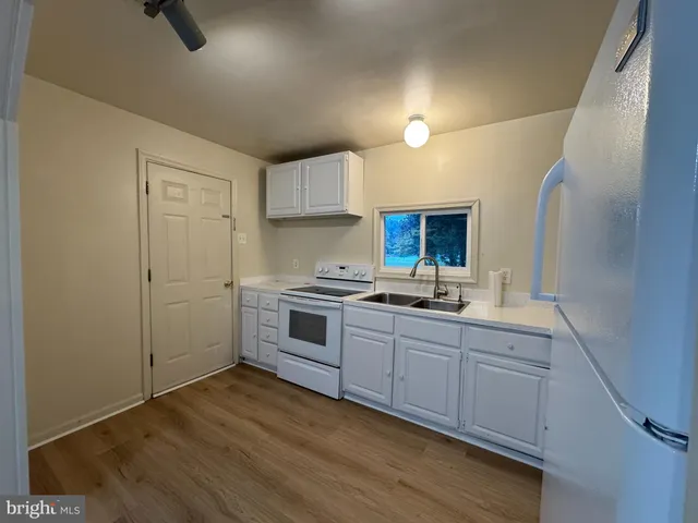 a kitchen with sink cabinets and stove
