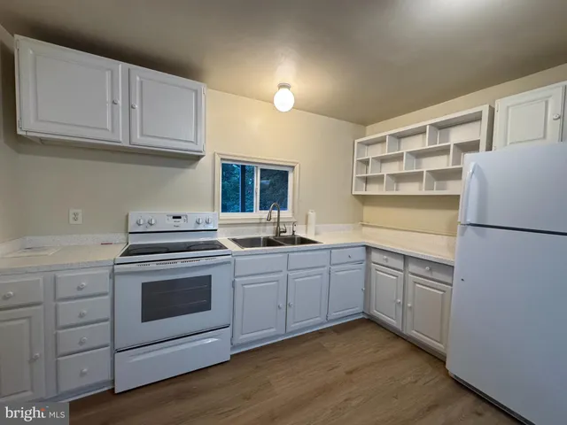 a kitchen with a sink cabinets and stainless steel appliances