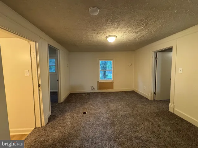 a view of an empty room and a window