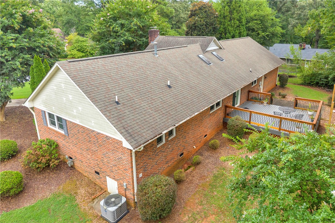 103 Colleton Court Clemson, SC 29631 - Photo 38 of 49 A spacious wooden deck extends from the brick exterior under a classic shingle roof.