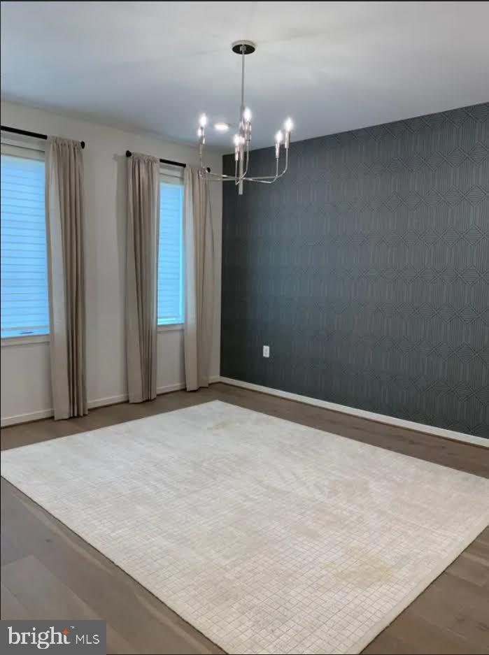 1870 Easterly Road Reston, VA 20190 - Photo 17 of 33 an empty room with a chandelier fan and windows
