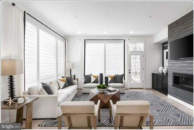 a living room with fireplace furniture and a flat screen tv