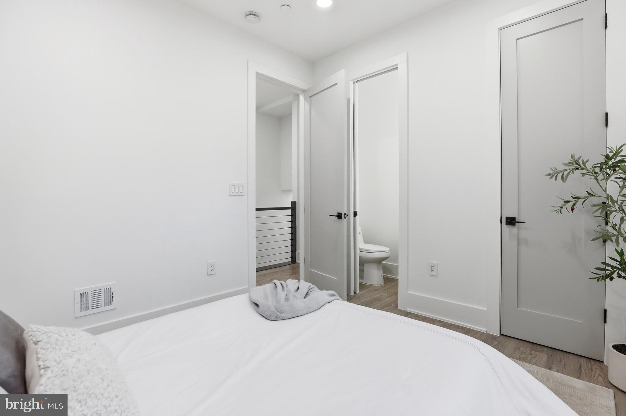 1140 Oates Street Northeast, Unit 101 Washington, DC 20002 - Photo 14 of 31 a bedroom with a bed and a table