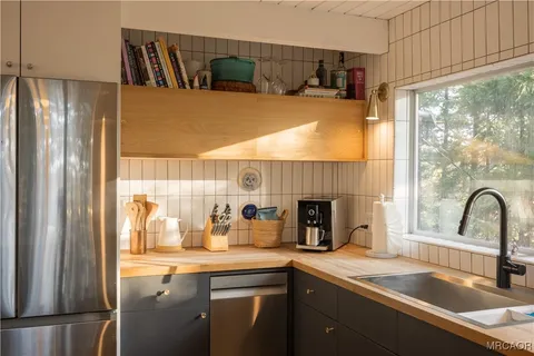 a kitchen with a sink and a refrigerator