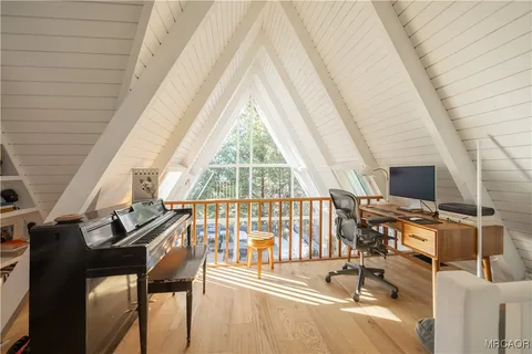 a view of a room with wooden floor and windows