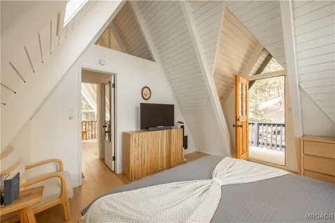 a bedroom with a bed and flat screen tv