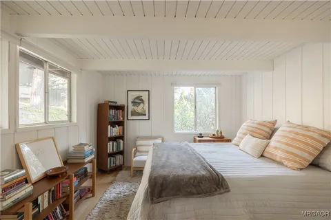 a bedroom with a bed furniture and a window