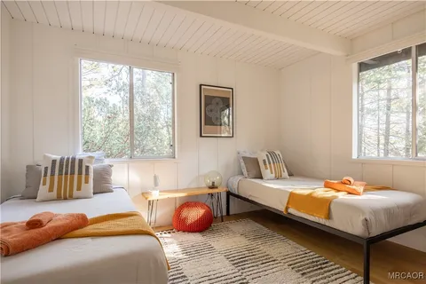 a bedroom with furniture and a large window