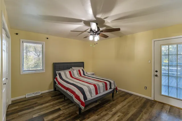 a bedroom with a bed and a chandelier