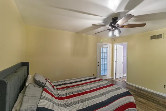 a bedroom with a bed and a chandelier