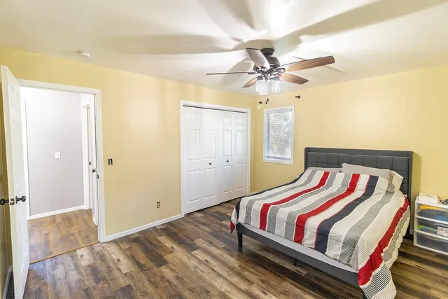 a bedroom with a bed and a chandelier