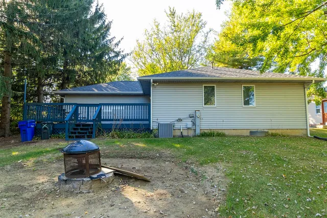 a view of a house with a yard patio and fire pit