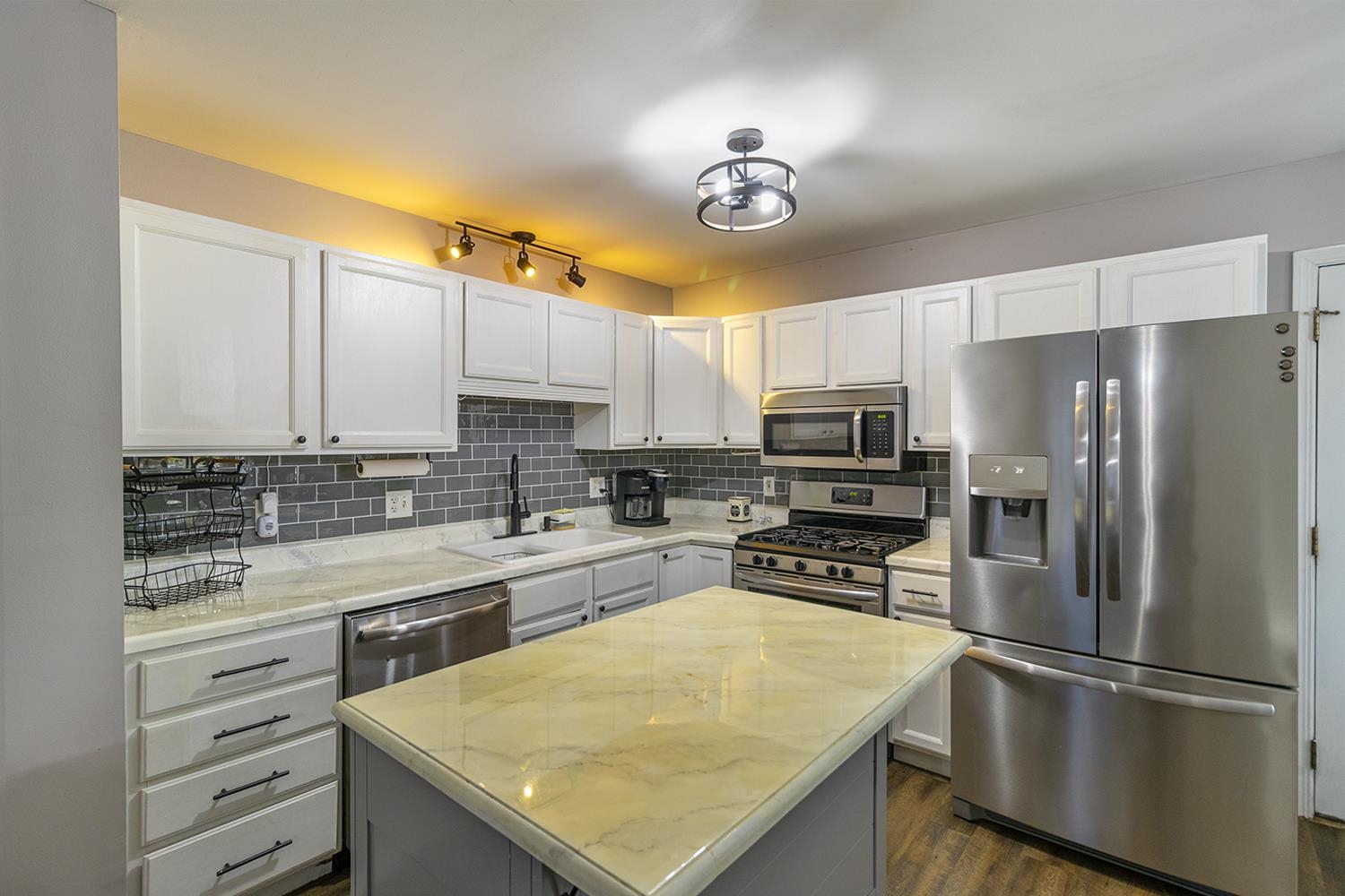 115 Lamplighter Loop Southeast Poplar Grove, IL 61065 - Photo 5 of 27 a kitchen with a refrigerator a sink and cabinets