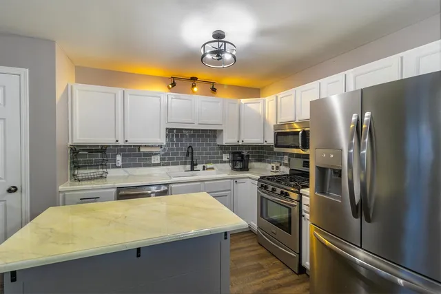a kitchen with a refrigerator and a sink
