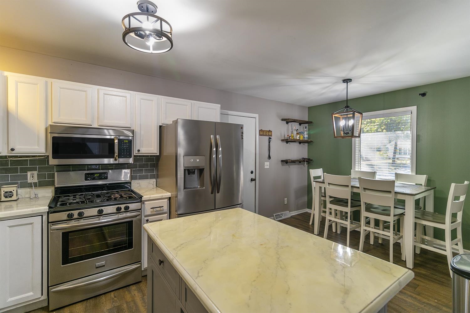 115 Lamplighter Loop Southeast Poplar Grove, IL 61065 - Photo 7 of 27 a kitchen with stainless steel appliances a stove a microwave and a refrigerator