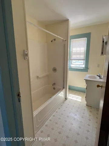 a bathroom with a bathtub and a shower