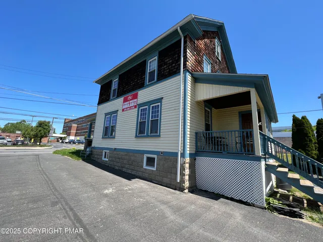 a view of a house with a street