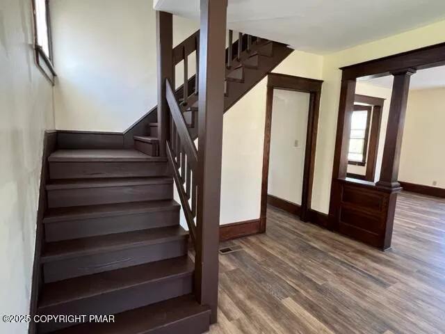 a view of entryway and hall with wooden floor